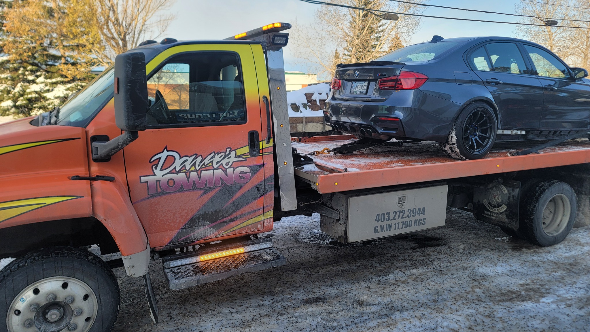Tow truck assisting vehicle in winter conditions in Calgary