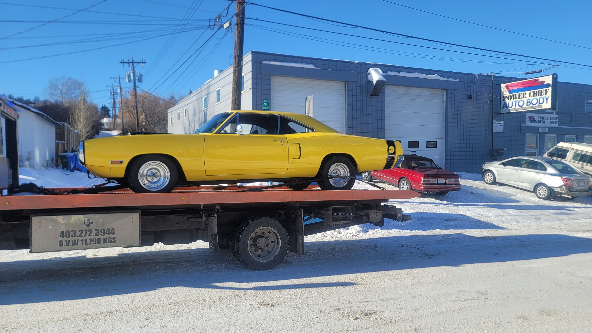 Classic muscle car on flatbed tow truck in Calgary